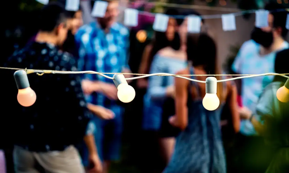 Neighbors gathered under string lights