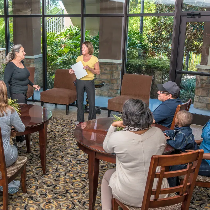 People gathering around tables at a community center