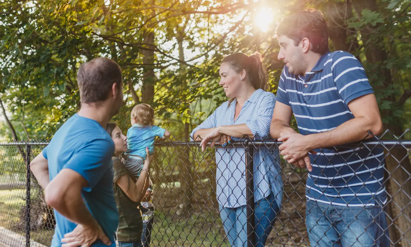Neighbors of different ages talking together outdoors