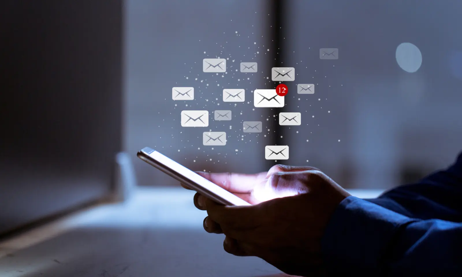 A person checking a phone amid a flurry of email notifications